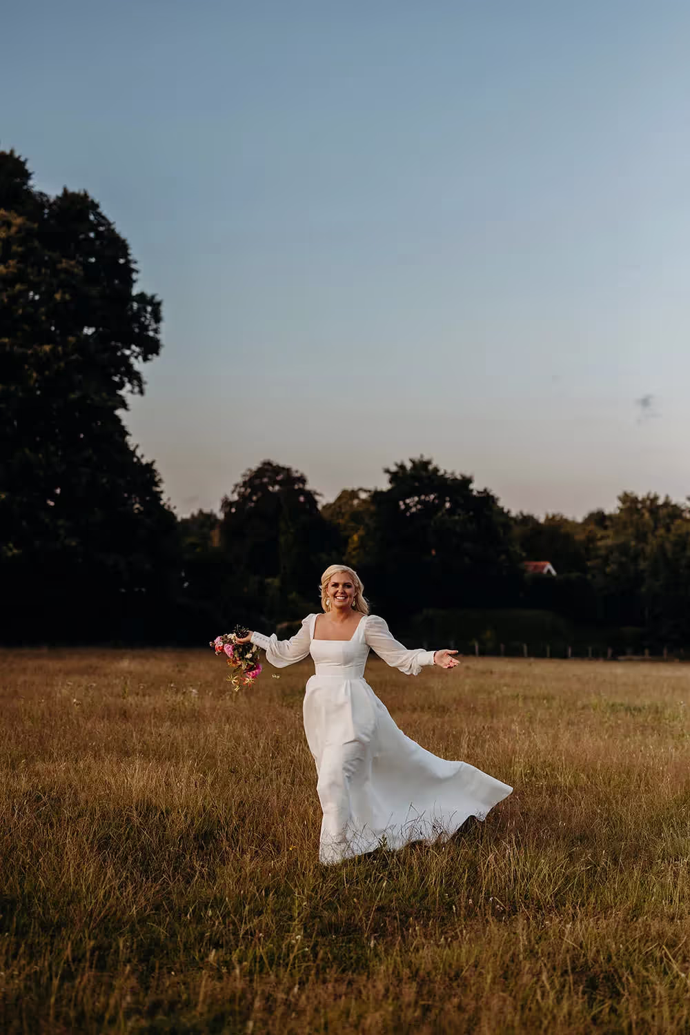 Bride with bouquet during sunset photographs