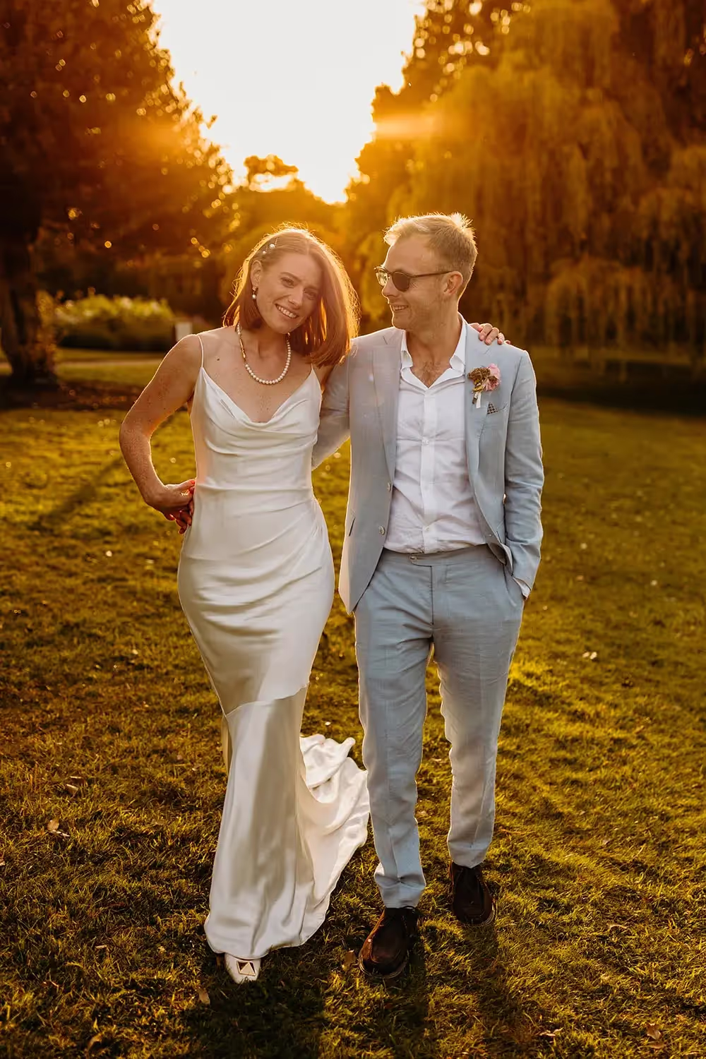 Bride and groom at sunset at riverside wedding near Windsor