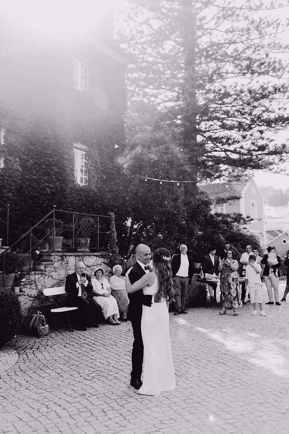 Couple first dance at Portugal wedding as guests watch in the backround